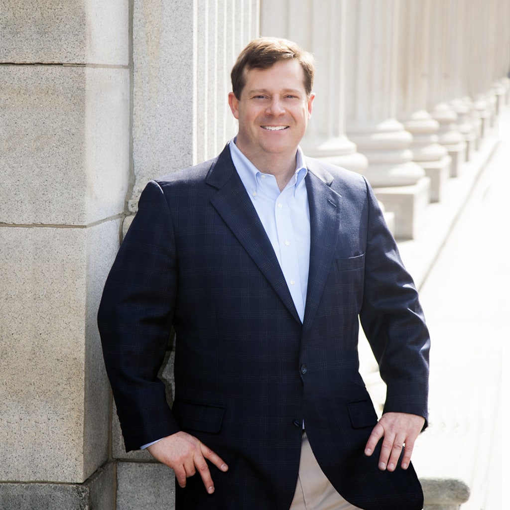 Business portrait outdoors by stone columns