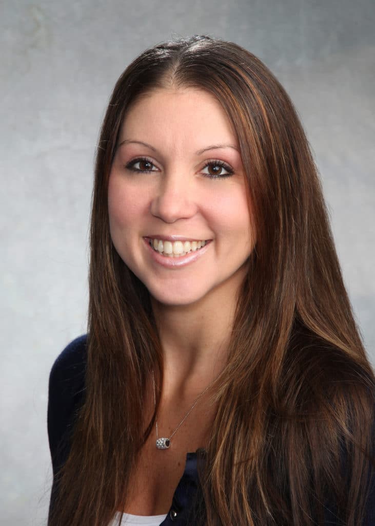Corporate headshot on a soft gray backdrop from a matched company team set