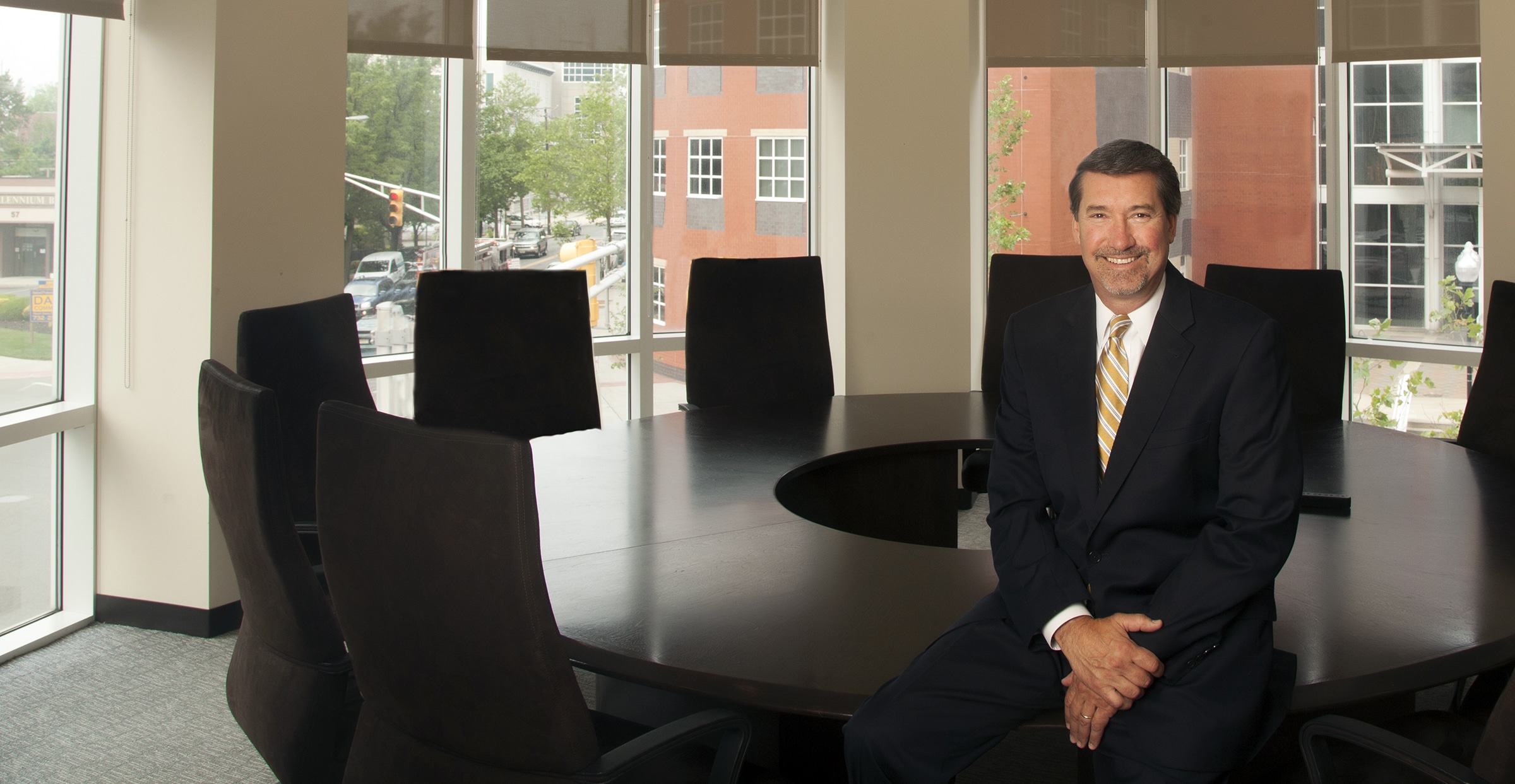 Executive in a boardroom with large windows