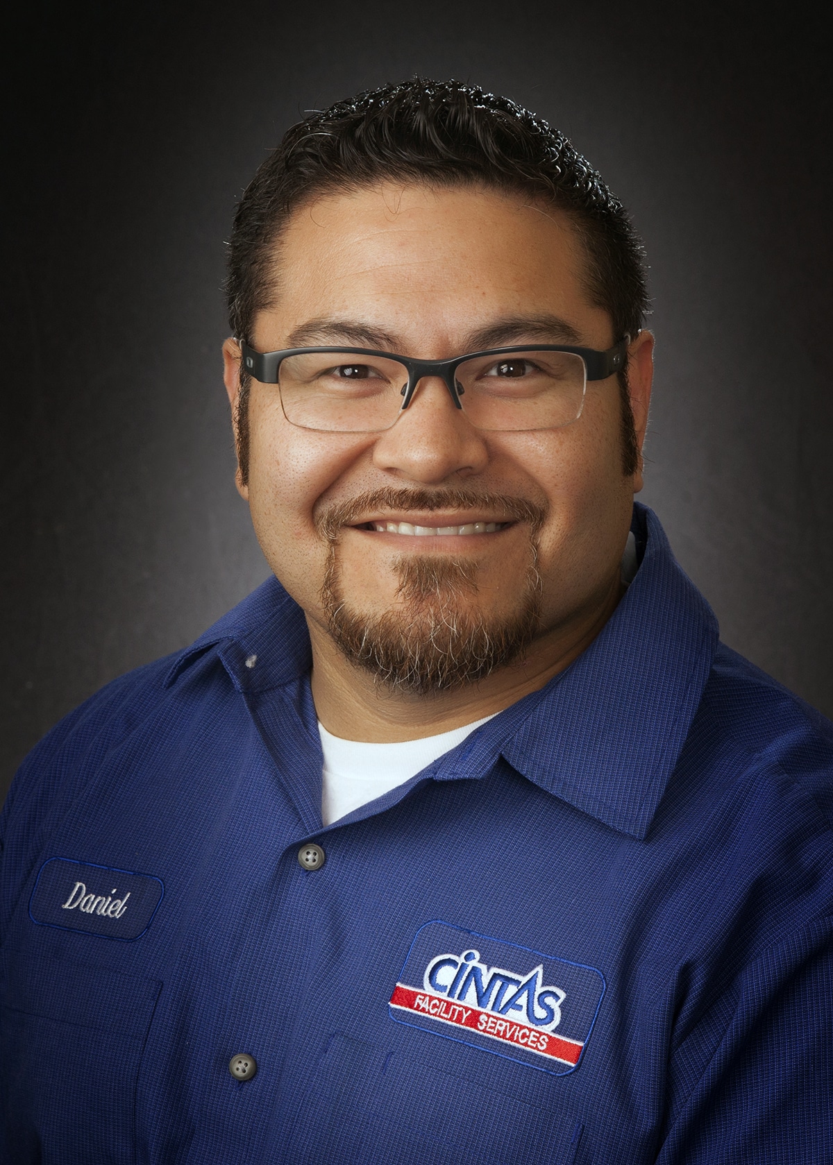 Employee headshot in a company uniform, photographed on location for a staff directory