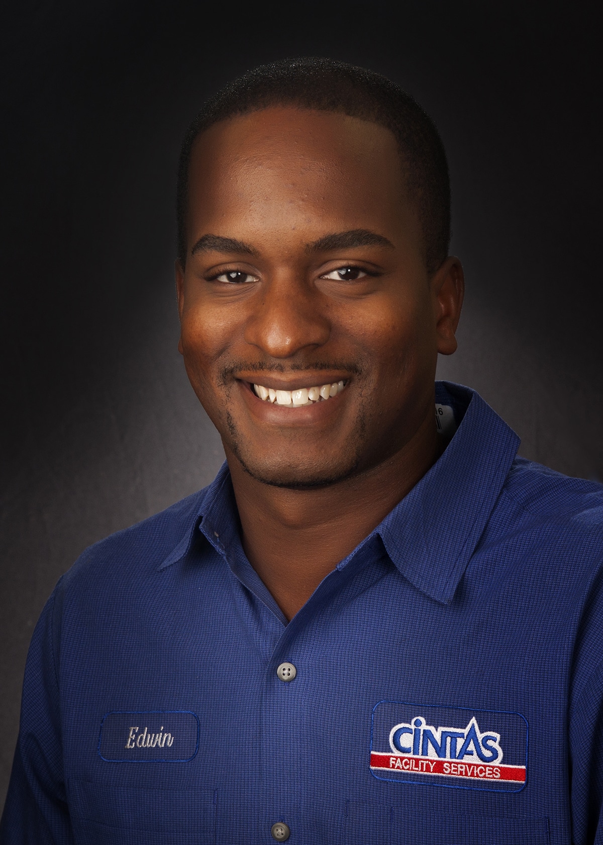 Employee headshot in a company uniform, photographed on location for a staff directory