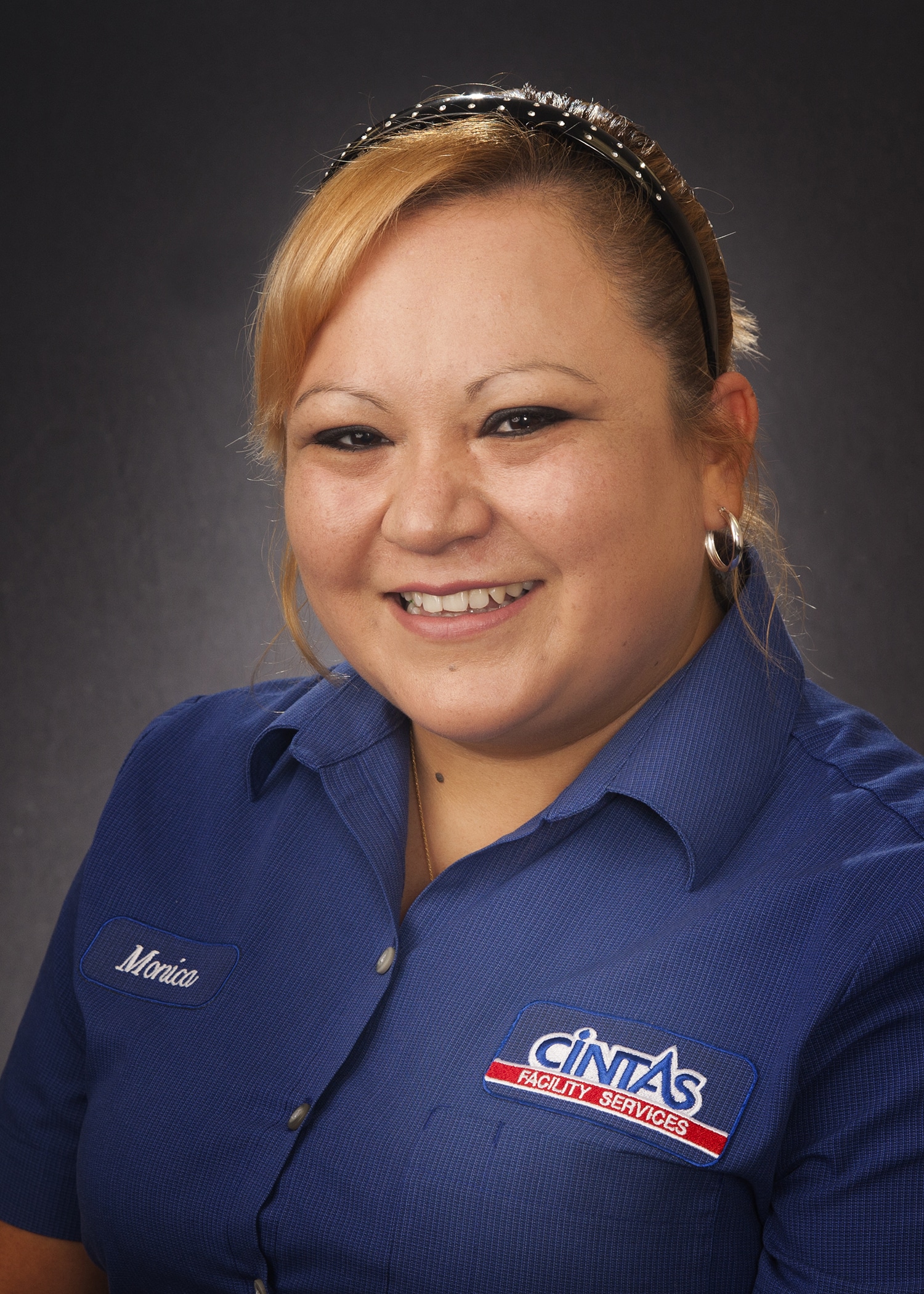 Employee headshot in a company uniform, photographed on location for a staff directory