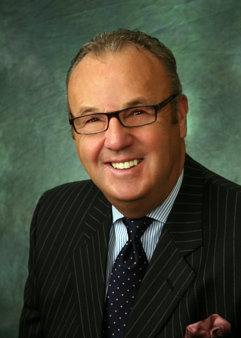 Senior executive portrait on a green painted backdrop