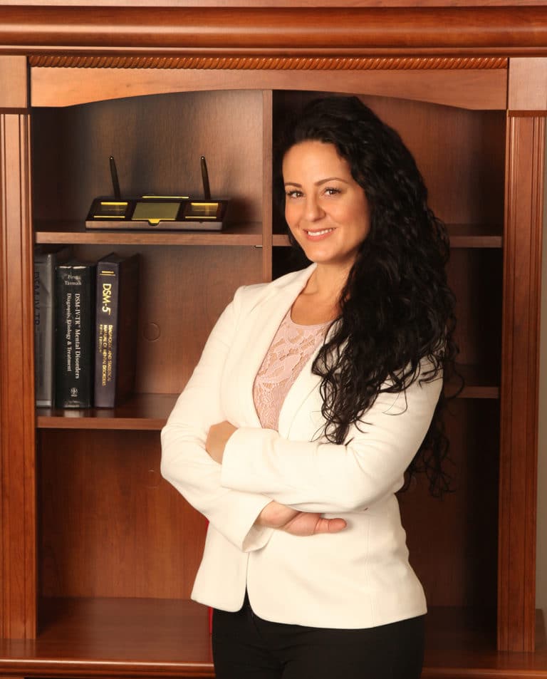 Professional portrait in a home office with bookshelves