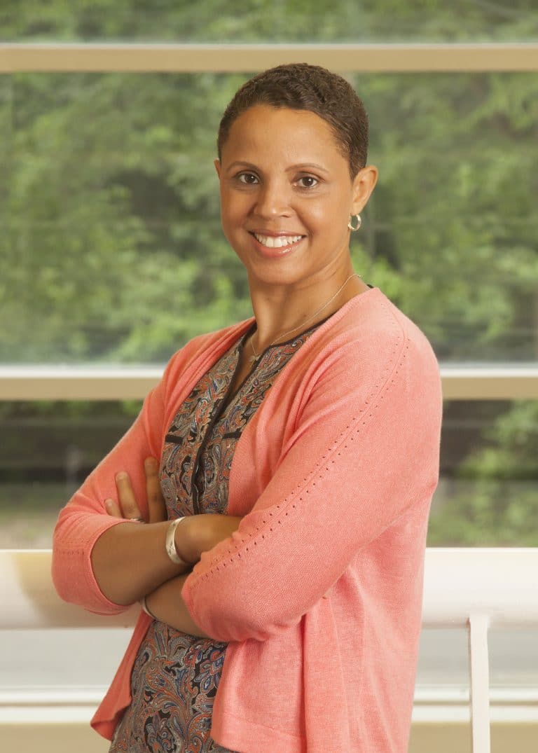 Professional portrait in front of a garden window