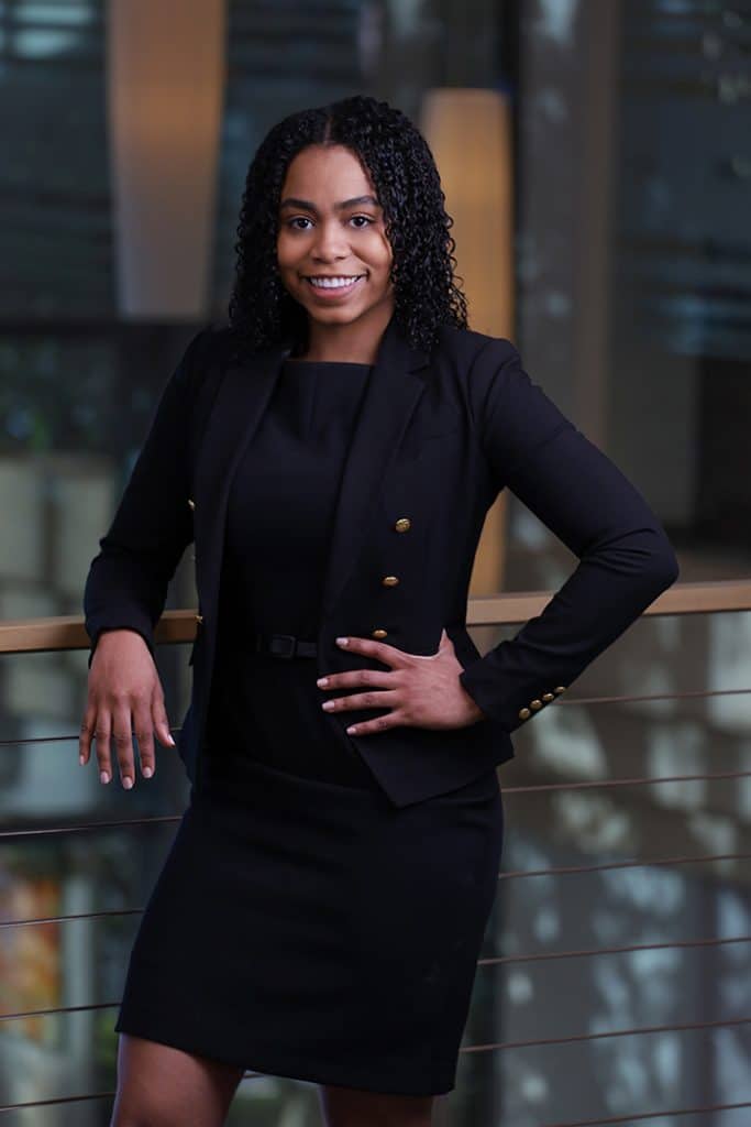 Executive portrait standing in a modern office atrium