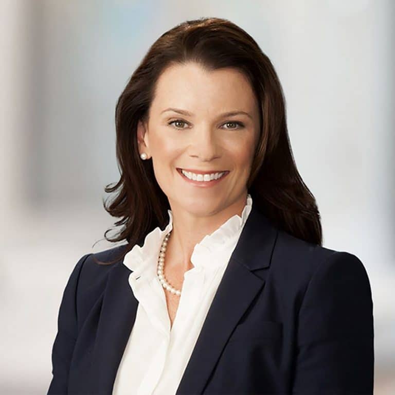 Executive portrait of a woman in a bright office setting