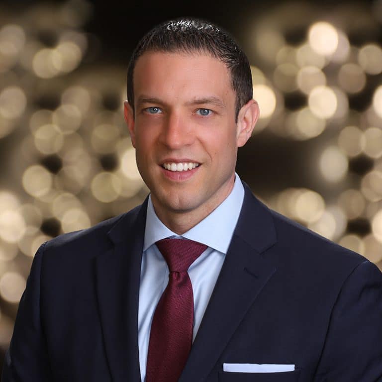 Executive portrait with warm bokeh lights in the background