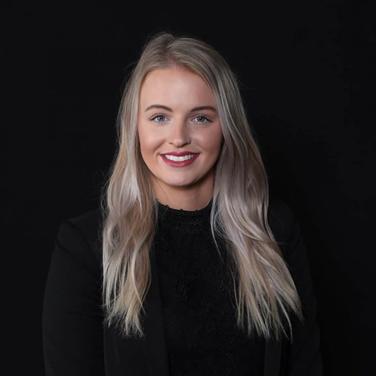 Studio headshot on a black backdrop